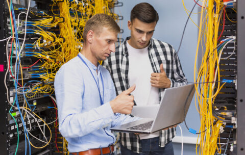 young-network-engineers-with-laptop-medium-shot